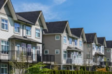 A row of rental townhouses on a sunny day