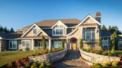A large home with stone walls and landscaping