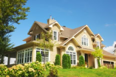 Yellow two story country house on summer day