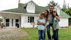 A happy family in front of their new home