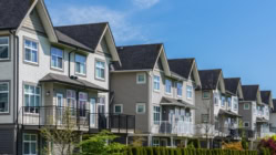 A picture of a townhouse, houses lined up in a clean and neat way.