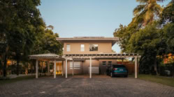 A picture of a house with a car parked on the outside