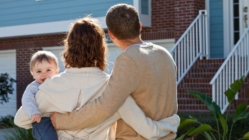 Young family looking at house they are interested in buying.