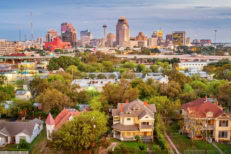 Stock photograph of a residential district and the downtown skyline of San Antonio Texas USA at twilight.