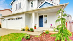 Single family house with two levels and a short driveway.