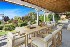 Picture of a backyard with a dining table outside