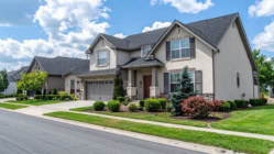 A picture of a house with great greenery on the lawn