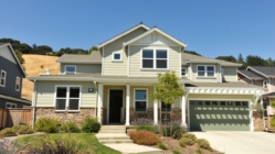 Single family house with two levels and a short driveway.