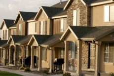 A picture of a line of houses under the sunset