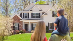 Veteran with their family, looking at their new home.
