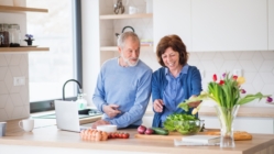 Old married couple spending time together in the kitchen