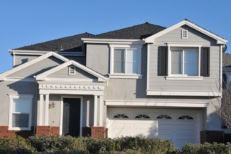 Single family house with two levels and a short driveway.