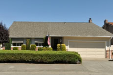 Single family house with one level and a short driveway.