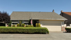 Single family house with one level and a short driveway.