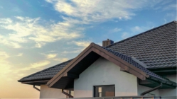 The slope of a metal roof against a blue evening sky